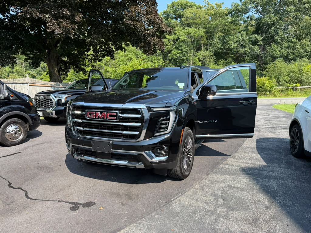 GMC Yukon XL front grille and passenger door open — Orange County Limousine