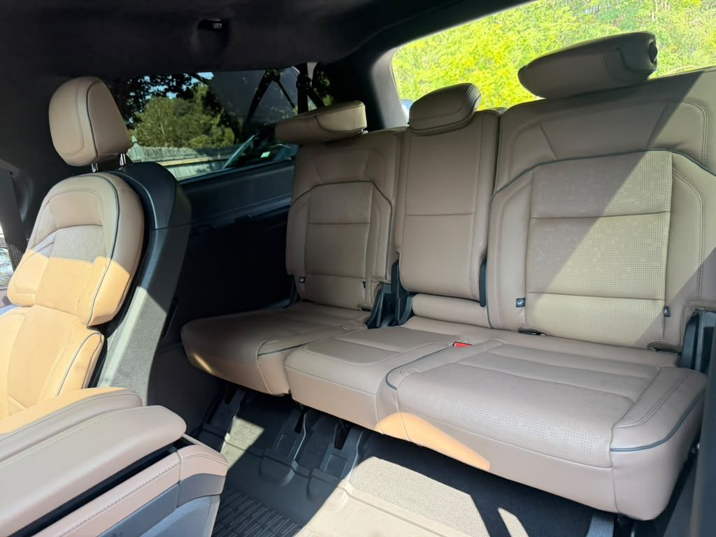 Third-row bench seating in tan leather inside the Lincoln Navigator SUV