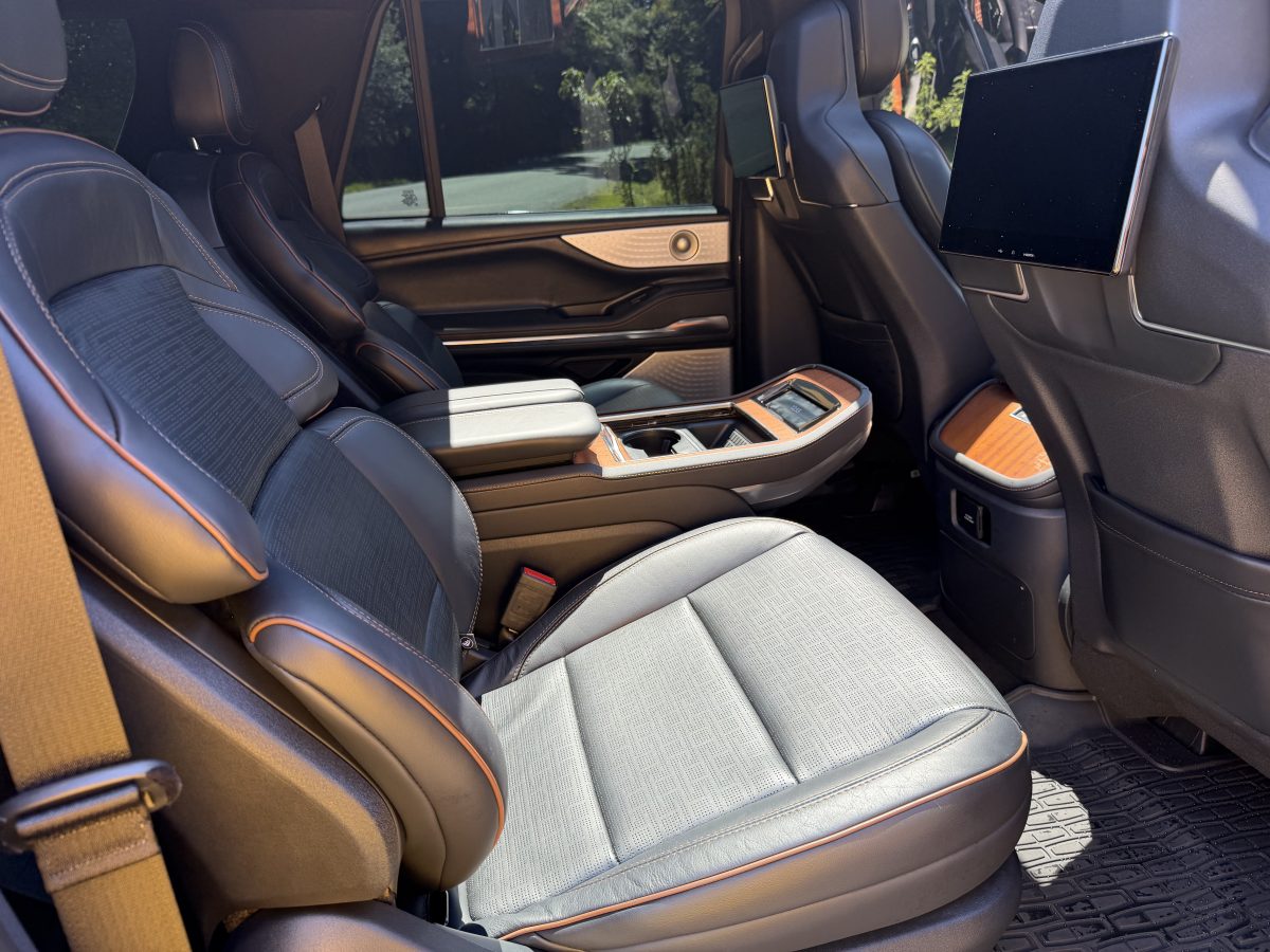 Second-row captain’s chairs in grey leather with orange piping inside the Lincoln Navigator Executive