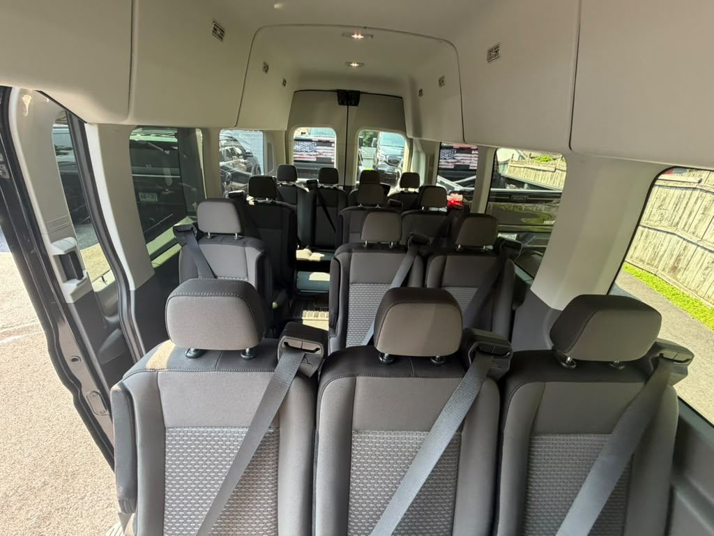 Interior seating rows inside the Ford Transit shuttle van